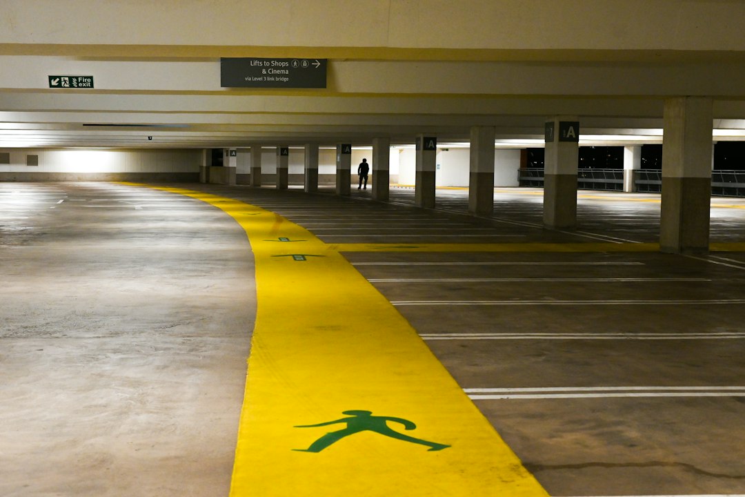 An empty parking garage with a yellow line painted on the floor in Allen, TX
