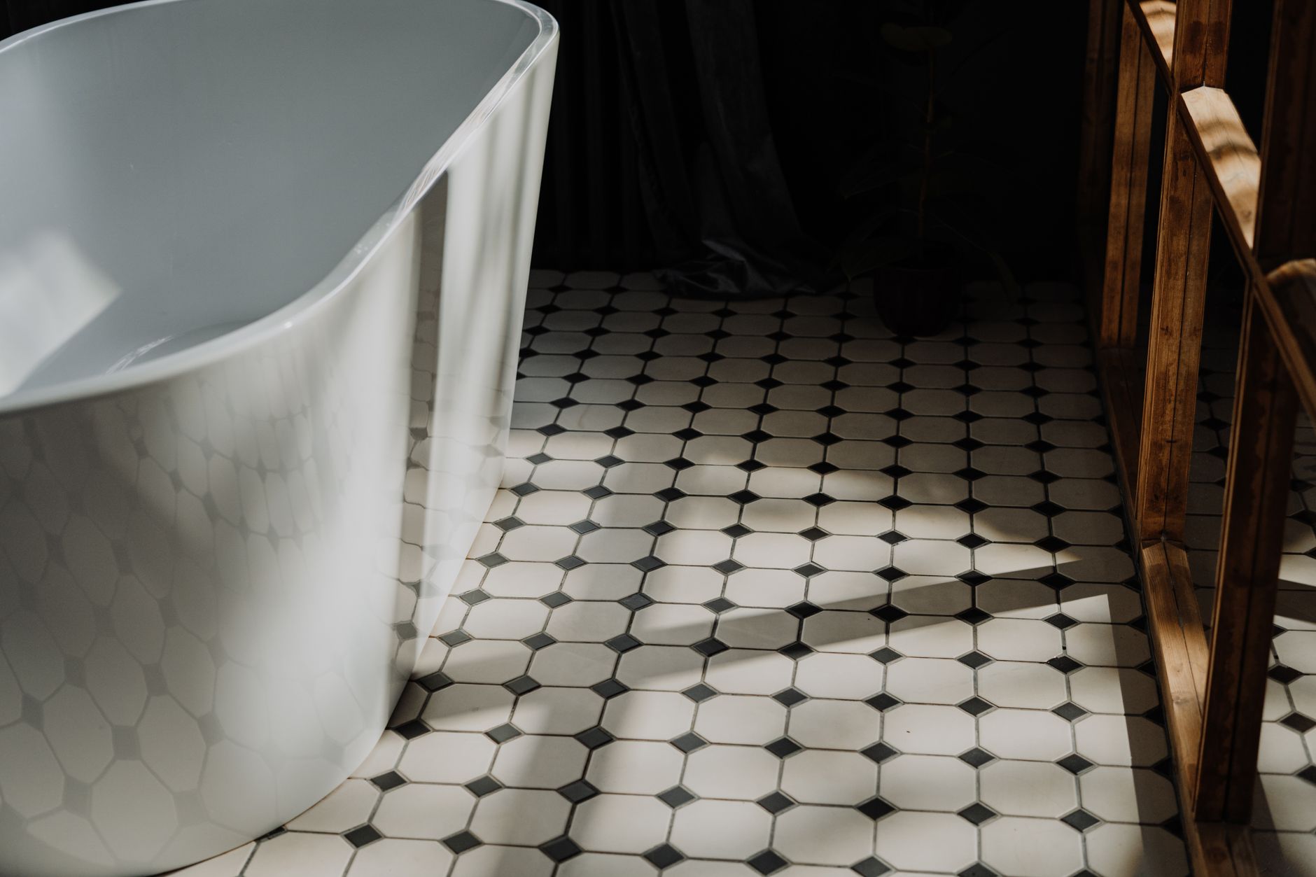 Minimalist bathroom with a freestanding tub and stylish hexagonal floor tiles, showcasing modern design in Allen, TX