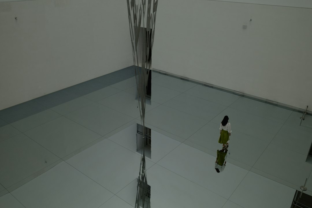 Ceiling tiles and wires are reflected on the floor in Allen, TX