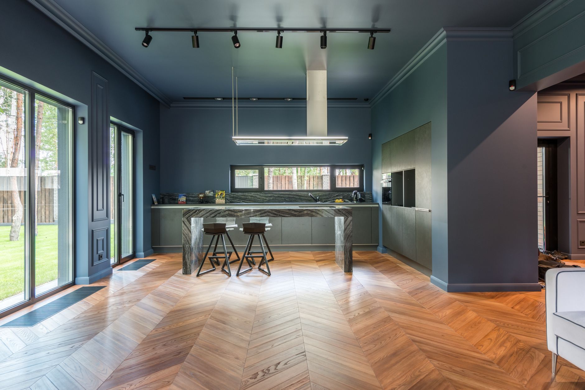 Spacious modern kitchen featuring chevron parquet flooring and sleek design in Allen, TX